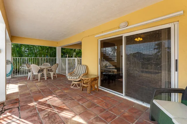 a view of a house with backyard porch and sitting area