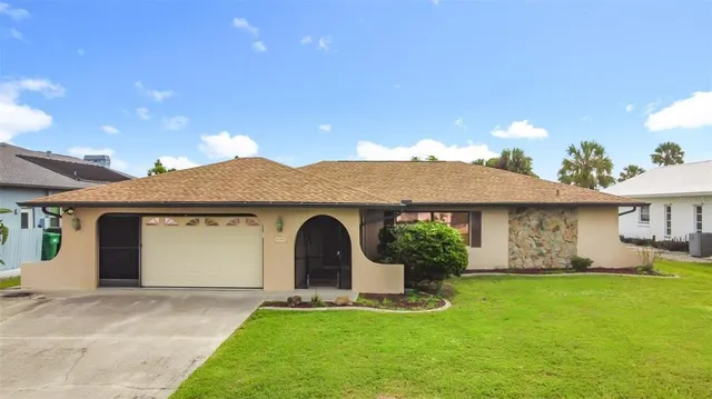 a front view of a house with a garden and plants