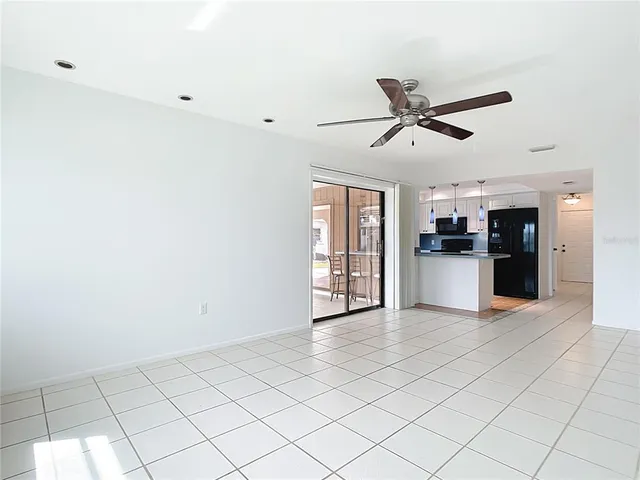 a view of a kitchen with a sink and a refrigerator