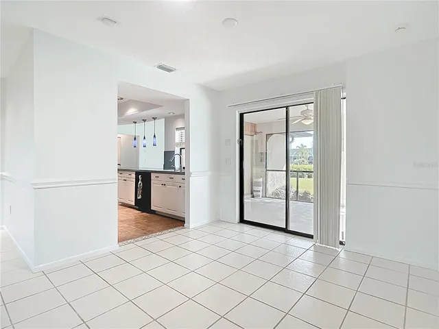 a view of a kitchen with an empty space and wooden floor