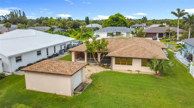 a aerial view of a house with a yard table and chairs
