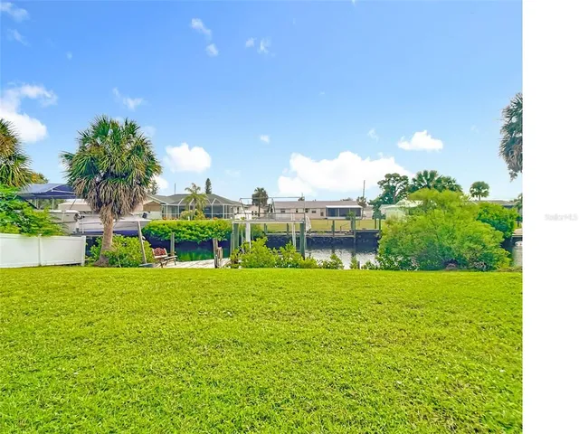 a view of a garden with a building in the background