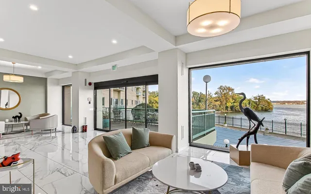a living room with furniture and a floor to ceiling window