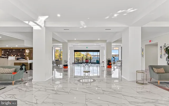 a view of a livingroom with furniture wooden floor and a window