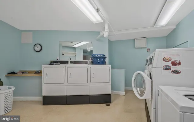 a utility room with cabinets washer and dryer
