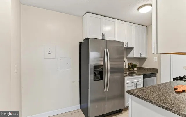 a kitchen with stainless steel appliances granite countertop a refrigerator and a sink