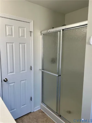 a bathroom with a glass door shower