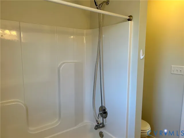 a bathroom with a shower and a toilet