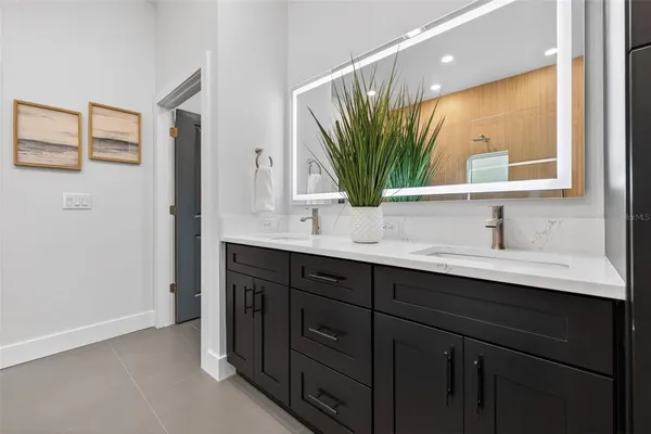 a bathroom with a double vanity sink and a mirror