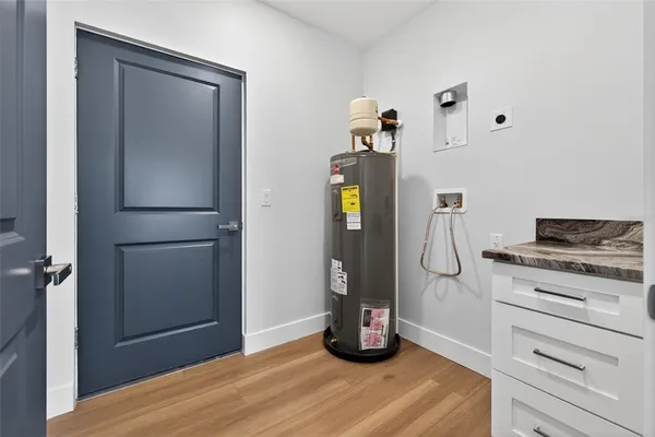 a bathroom with a granite countertop sink a toilet and mirror