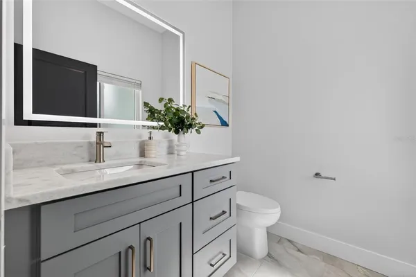 a view of a hallway with wooden floor and stairs