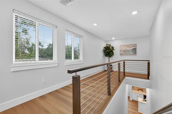 a view of entryway and hall with wooden floor
