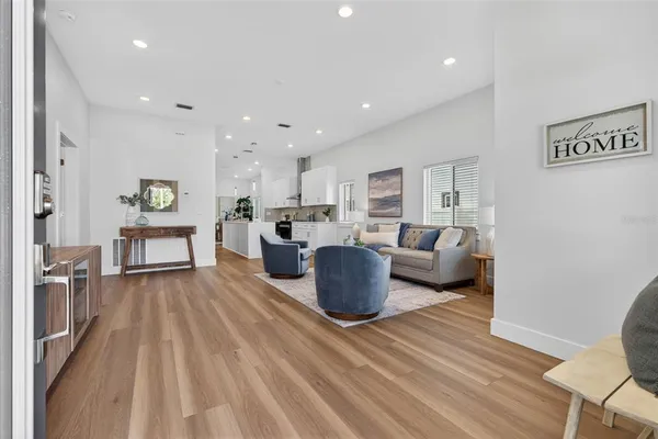 a living room with furniture and kitchen view