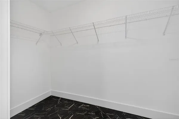 a view of empty room with wooden floor and window