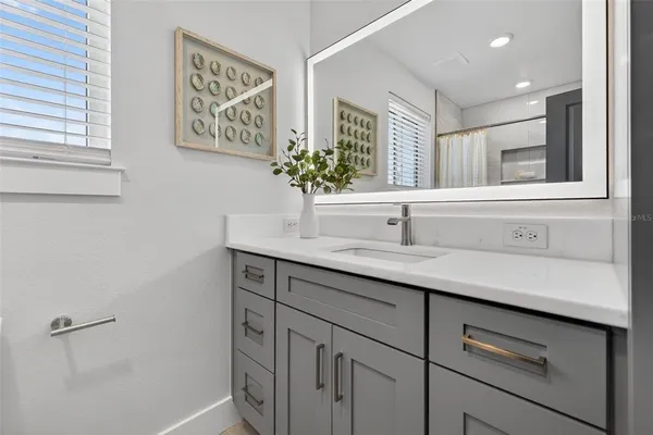 a bathroom with a glass shower door
