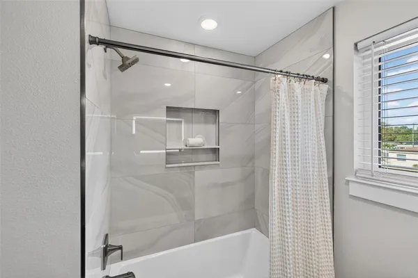 a bathroom with a granite countertop sink and mirror