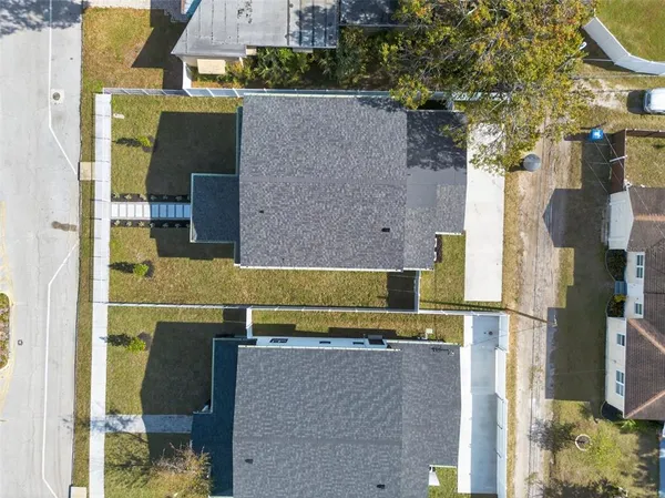 an aerial view of residential houses with outdoor space