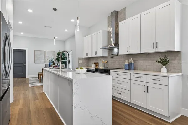 a kitchen with white cabinets and white appliances