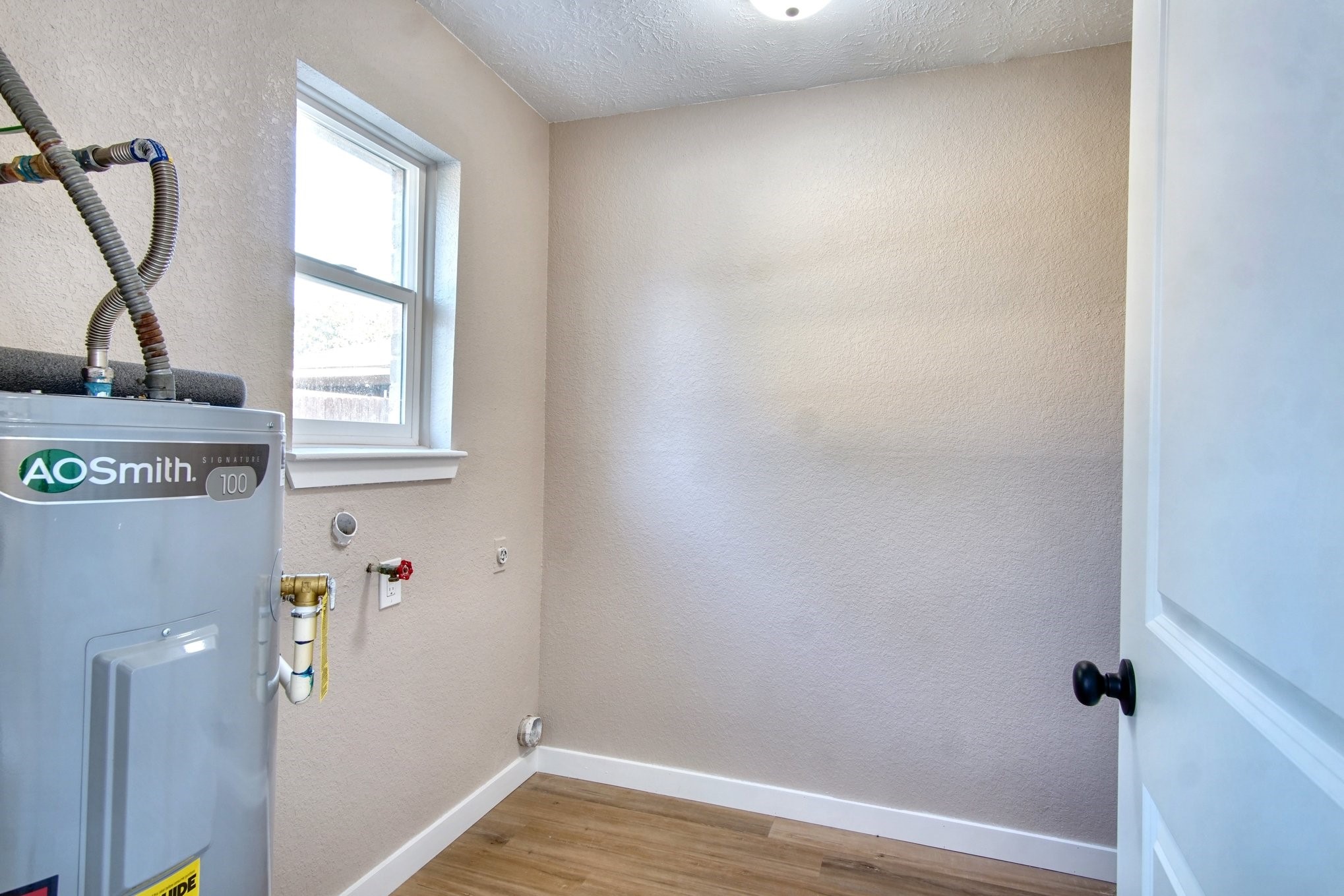 7511 Weatherhill Lane Houston, TX 77041 - Photo 37 of 40 Brand new water heater in utility room with a ton of work space