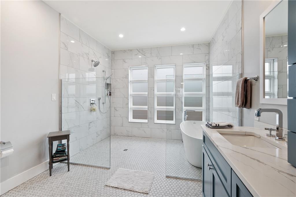 172 43rd Street Pittsburgh, PA 15201 - Photo 18 of 25 a bathroom with a granite countertop sink a toilet a large mirror and shower