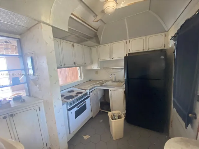 a kitchen with a refrigerator and a stove