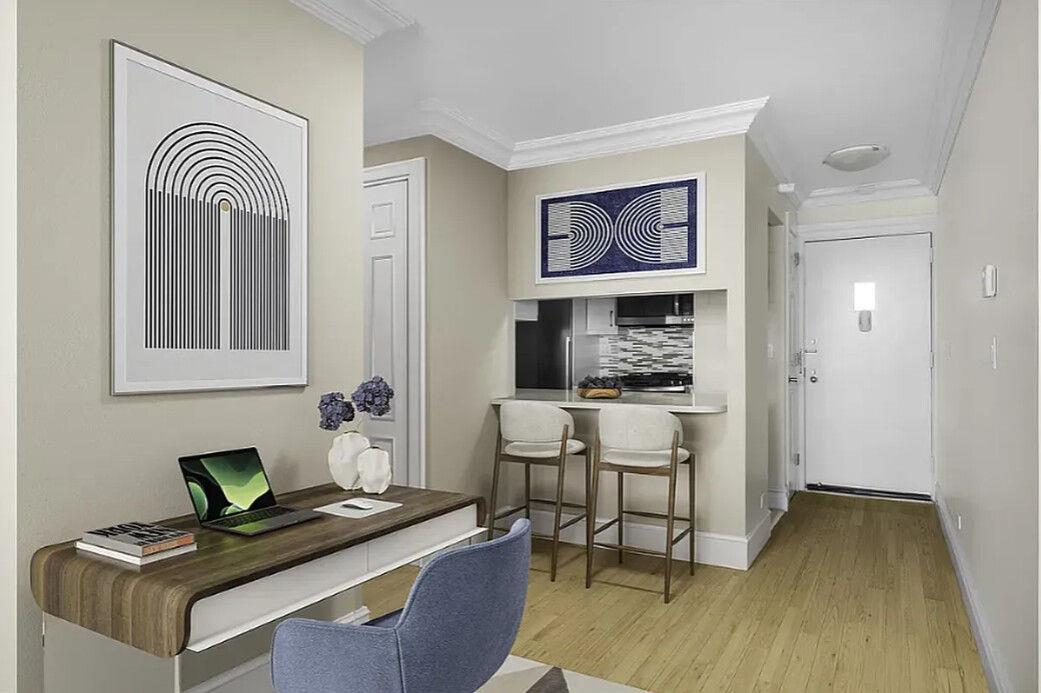 204 Rector Place, Unit 10L Manhattan, NY 10280 - Photo 4 of 10 a room with furniture a desk and chair with wooden floor