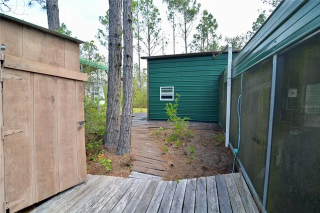 a view of house with a yard and sitting area