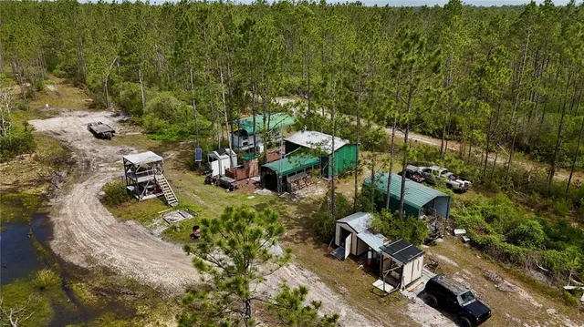 an aerial view of a house with a yard basket ball court and outdoor seating