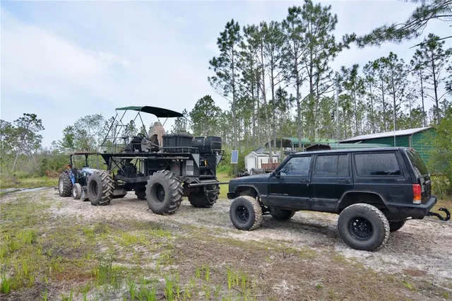 a view of a lounge chair and table in the backyard of the house