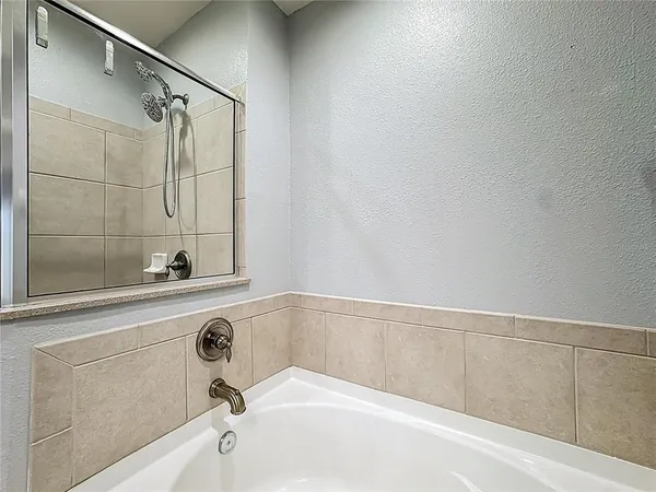 a bathroom with a bathtub and shower