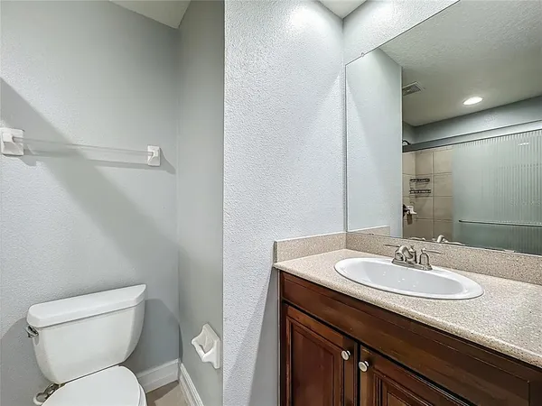 a bathroom with a sink toilet and a mirror