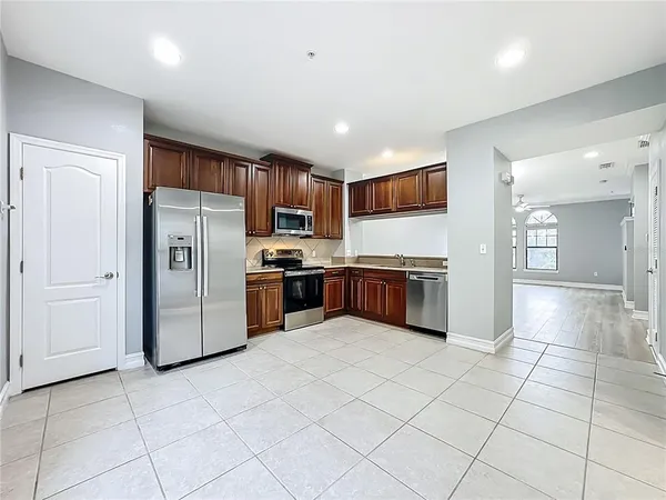 a kitchen with stainless steel appliances granite countertop a refrigerator sink and cabinets