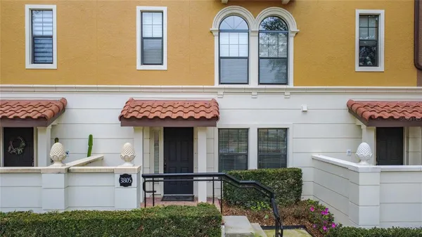 a view of brick house with large windows