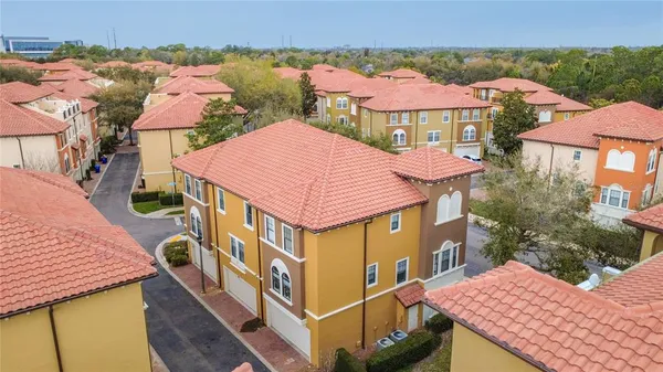 an aerial view of a house with a yard