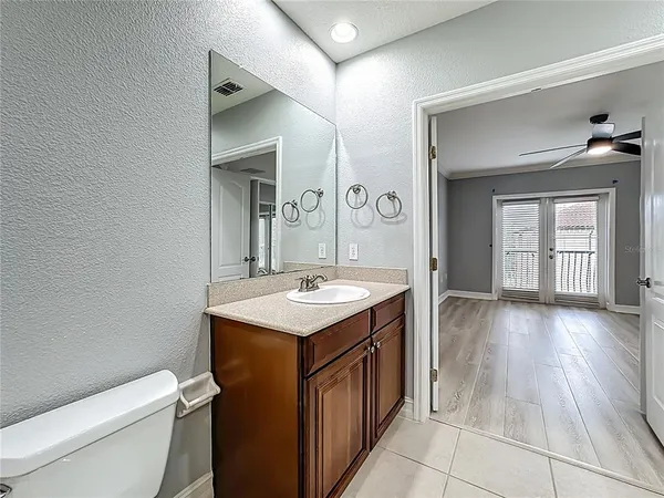 a bathroom with a sink a toilet and mirror