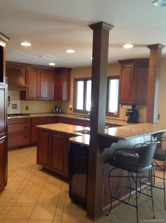 4421 Rounding Run Road Charlotte, NC 28277 - Photo 6 of 17 a kitchen with granite countertop a sink cabinets and stainless steel appliances