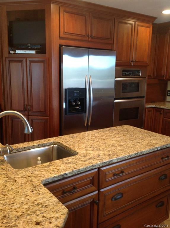 4421 Rounding Run Road Charlotte, NC 28277 - Photo 8 of 17 a kitchen with granite countertop a refrigerator and a sink