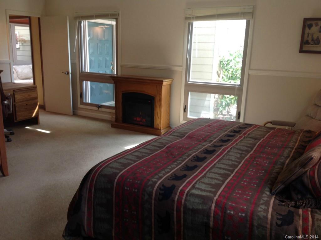 4421 Rounding Run Road Charlotte, NC 28277 - Photo 9 of 17 a bed sitting in a bedroom next to a window