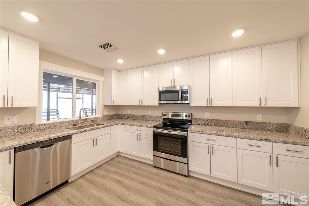 1070 Foothill Road Reno, NV 89511 - Photo 4 of 17 a kitchen with stainless steel appliances granite countertop a stove sink and cabinets