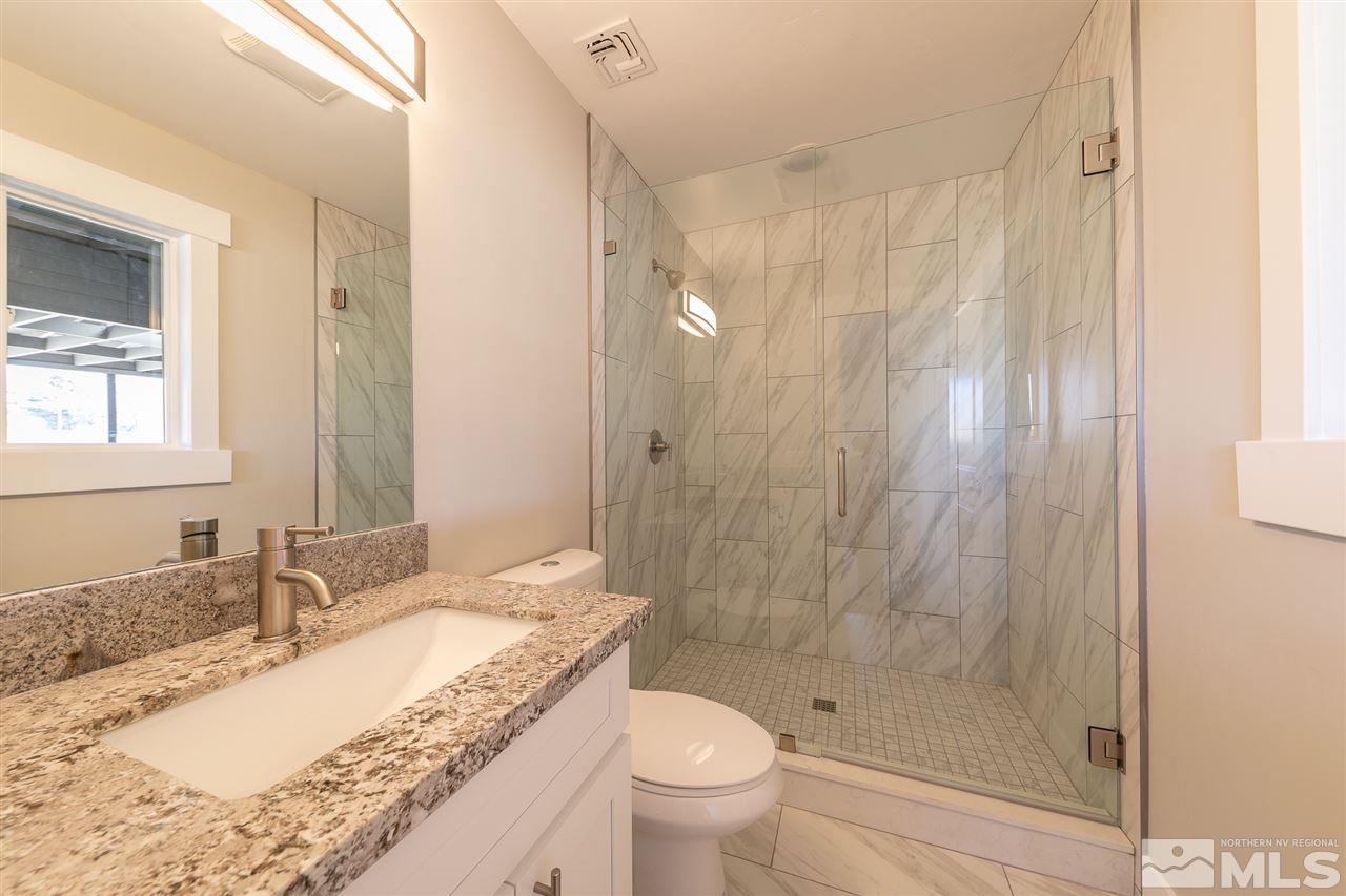 1070 Foothill Road Reno, NV 89511 - Photo 10 of 17 a bathroom with a granite countertop sink a toilet and shower