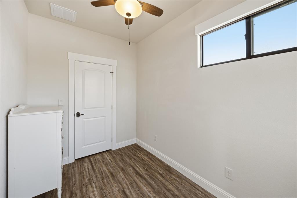 3105 Pastor Street Dallas, TX 75212 - Photo 24 of 28 Unfurnished bedroom with Luxury Vinyl wood like floors and a ceiling fan