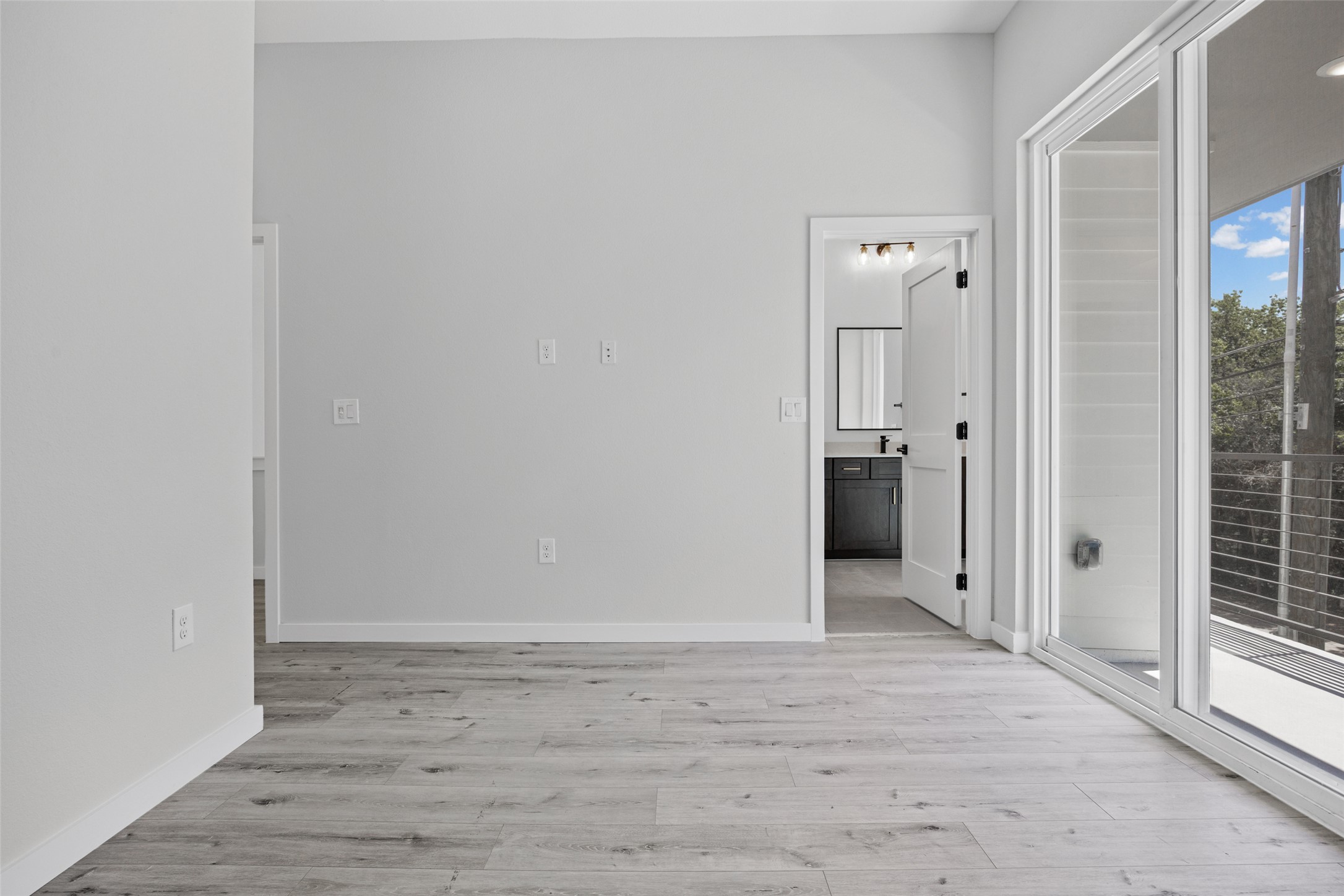 2000 Riverside Farms Road, Unit 5102 Austin, TX 78741 - Photo 16 of 25 Natural light floods this room, highlighting modern flooring and a private balcony.