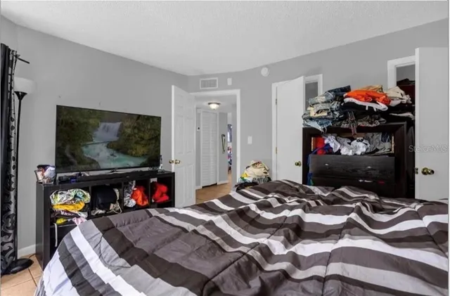 a bed sitting in a bedroom next to a window