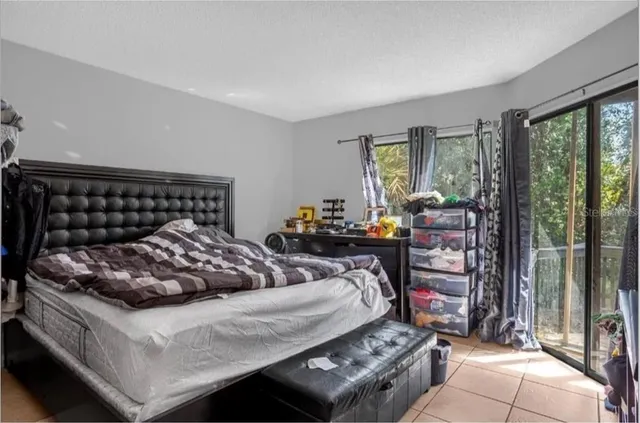 a bedroom with furniture and a flat screen tv