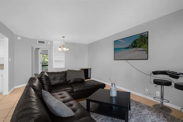 a living room with furniture and a potted plant