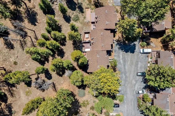 an aerial view of a house with a yard and garden