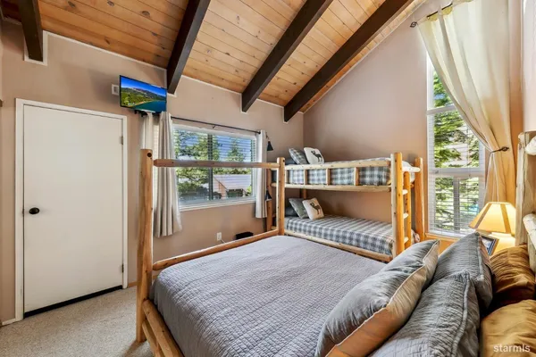 a bedroom with furniture and a large window