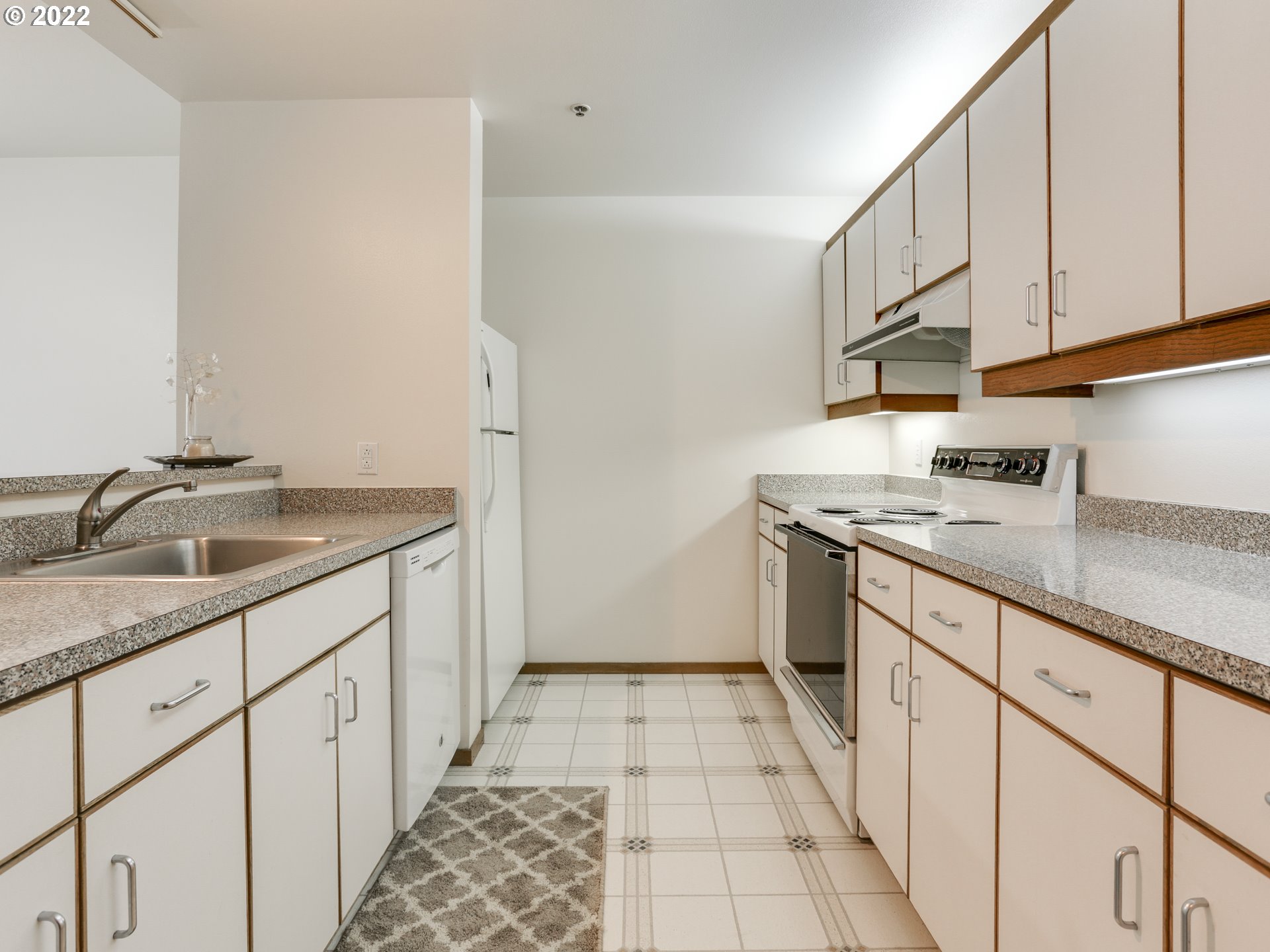 1730 South Harbor Way, Unit 405 Portland, OR 97201 - Photo 9 of 32 a kitchen with a sink and cabinets