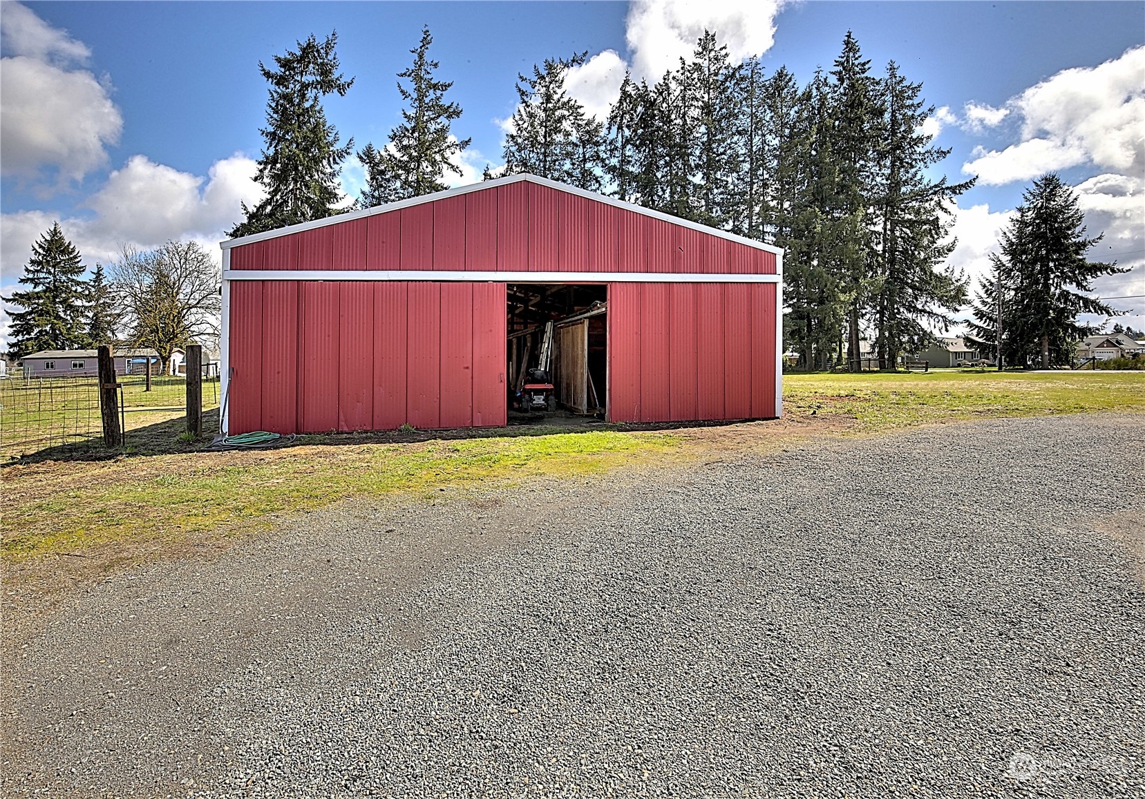 7230 196th Avenue Southwest Rochester, WA 98579 - Photo 12 of 39 a view of a house with a yard and garage