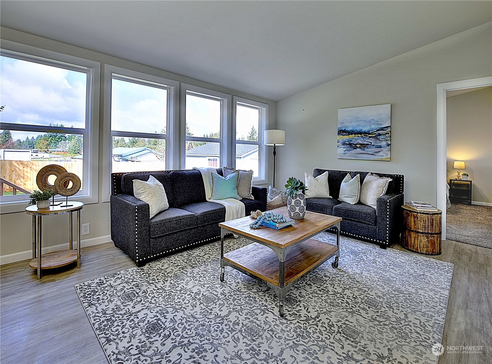 7230 196th Avenue Southwest Rochester, WA 98579 - Photo 13 of 39 a living room with furniture and a floor to ceiling window